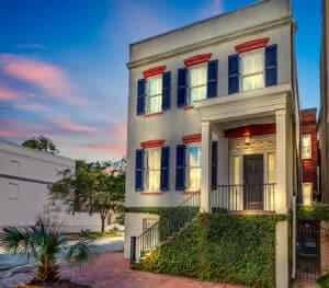 Experience the grandeur of The Hartcourt Manor, an extraordinary historic estate built in 1854, located just one block from Forsyth Park and Monterey Square. Nestled on a charming cobblestone street, this immaculately preserved property captures Savannah's rich heritage and Southern charm. Currently operating with three short-term vacation rental permits, it offers a unique blend of history and prime investment potential. The estate includes three distinct living spaces: the stately main house, a garden-level apartment, and a restored two-story carriage house, each with its own private entrance. Original architectural details combine with modern furnishings, included in the sale, for a perfect blend of old-world elegance and contemporary comfort. Whether you're seeking a luxurious residence or versatile investment, The Hartcourt Manor delivers an unmatched opportunity in one of Savannah’s most beloved locations.