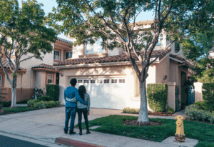 A couple walking through a gated resort-style community with their real estate agent