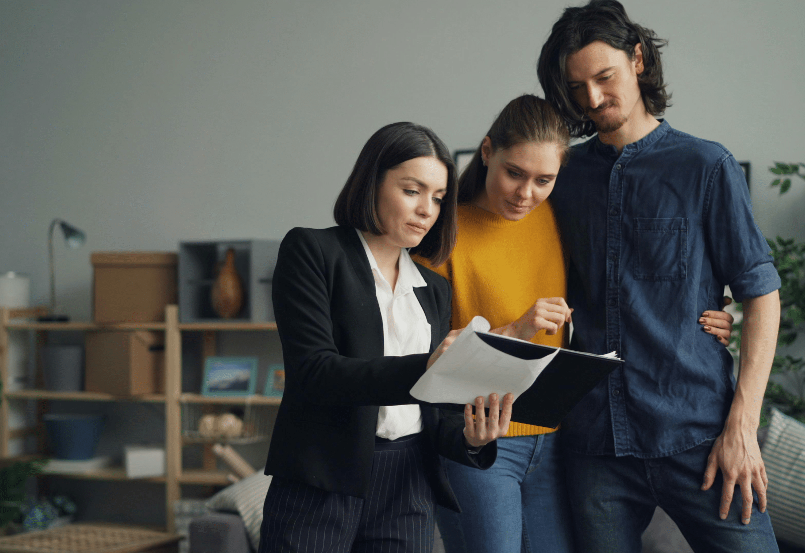 Realtor reviewing housing data with a client in an office